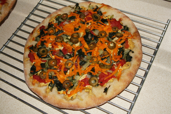 homemade sourdough pizza with homegrown greens and herbs