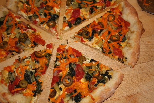 homemade sourdough pizza with homegrown greens and herbs